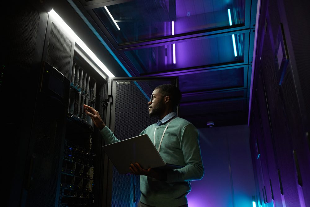 IT engineer inspecting server racks in a data centre